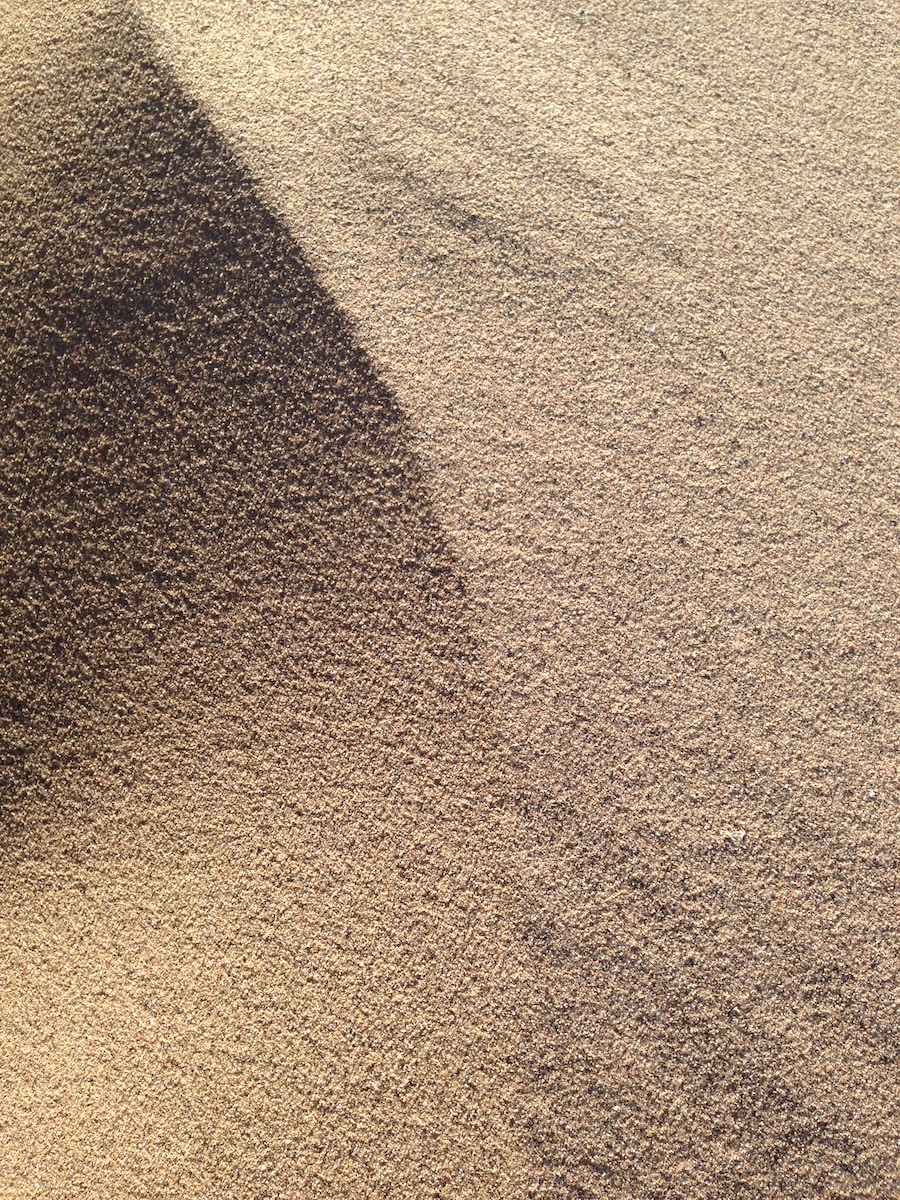 Photo by Drew McNaughton brown sand with shadow of person